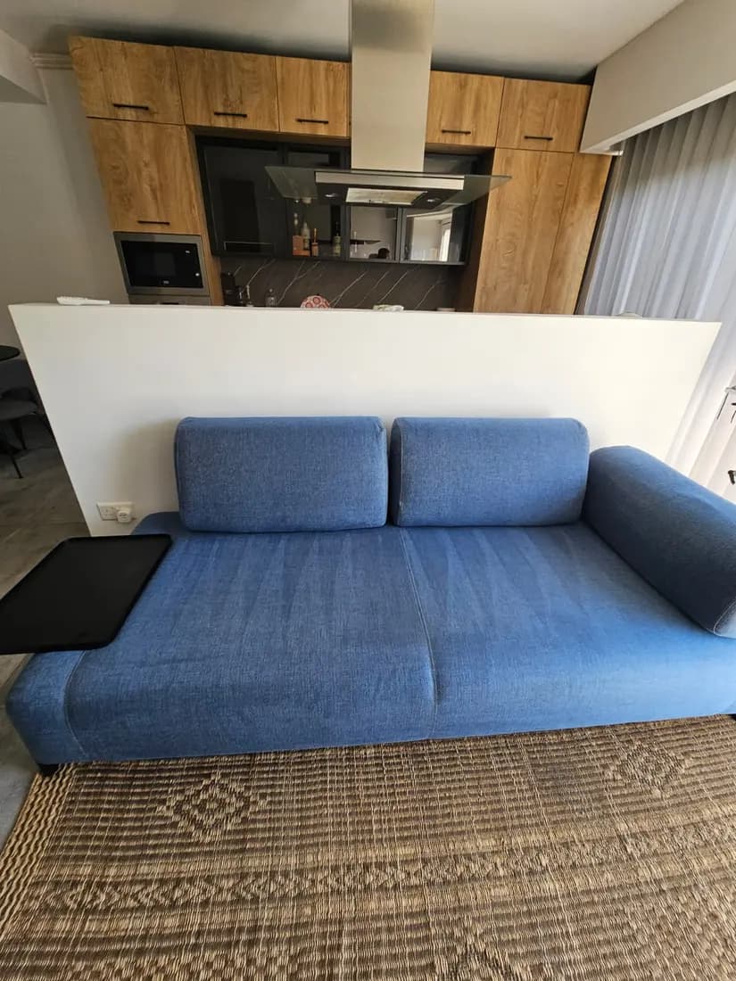 blue two-seater fabric sofa after professional cleaning by ARA Clean Malta
