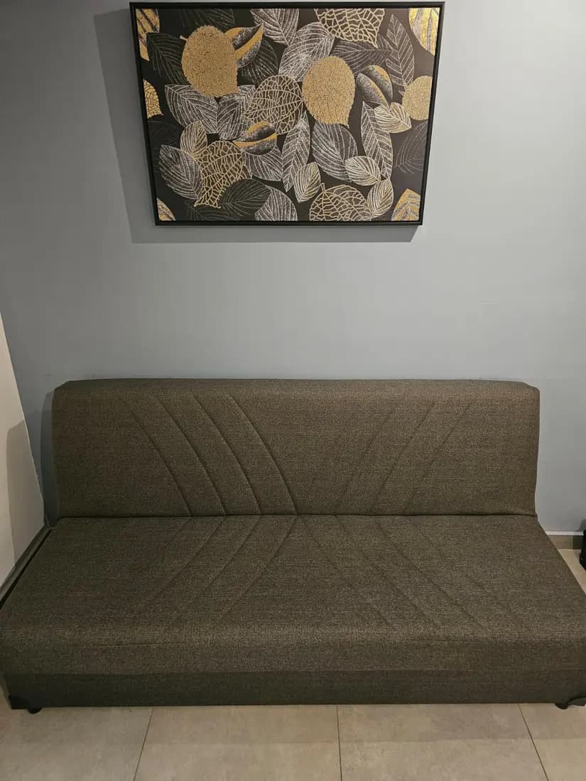 olive fabric sofa bed after professional cleaning by ARA Clean Malta